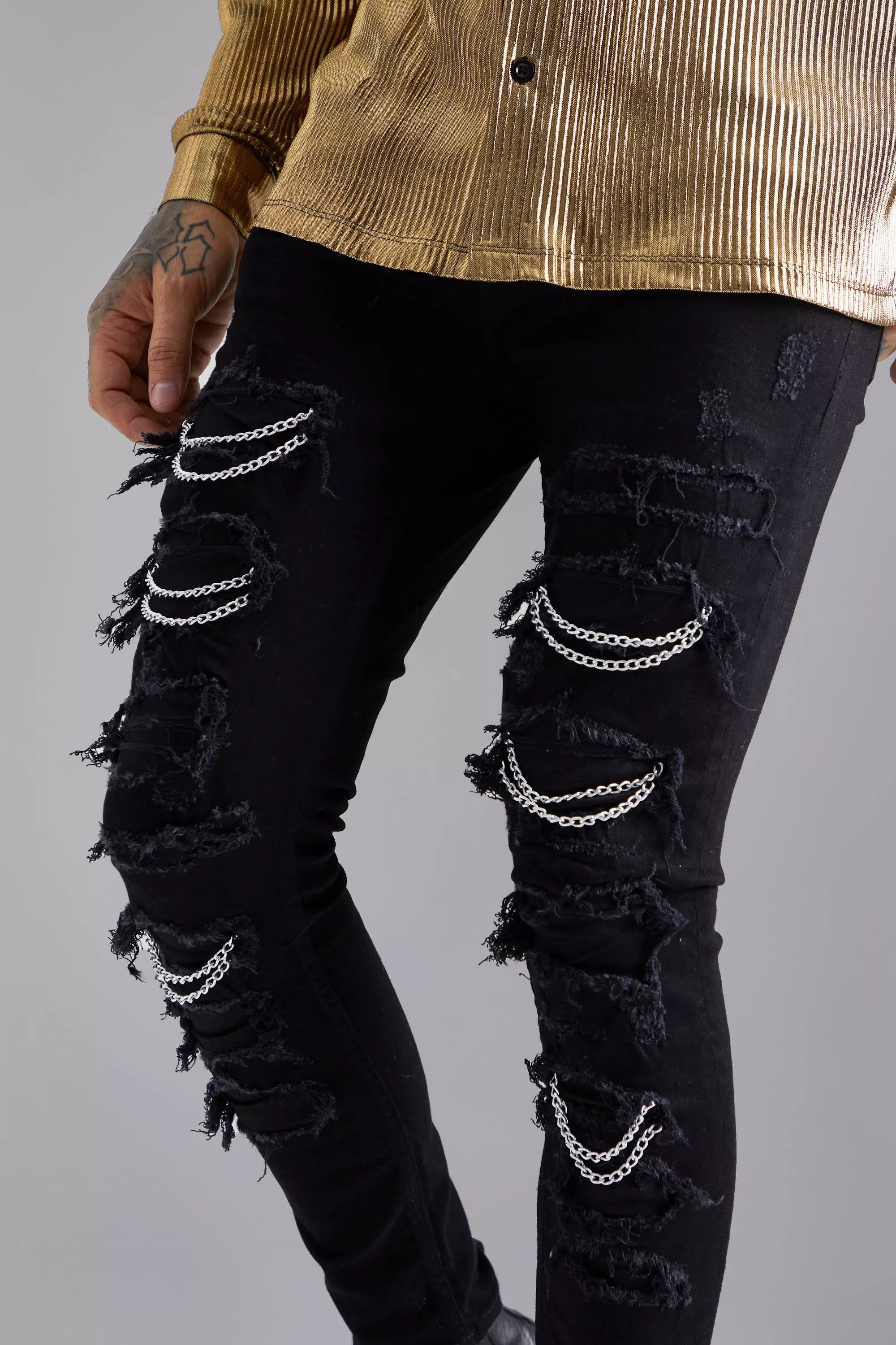 Jeans with store rips and chains